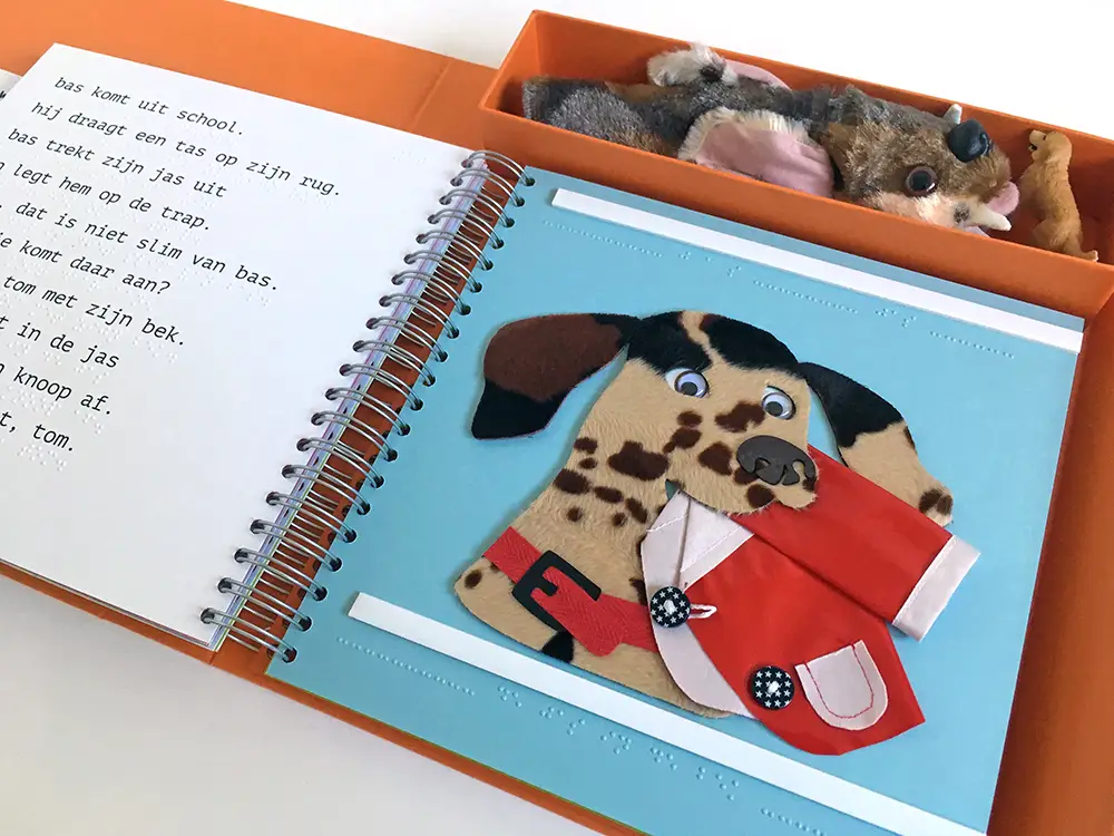 Double spread showing the story in braille, tactile illustration and bespoke hand puppet.