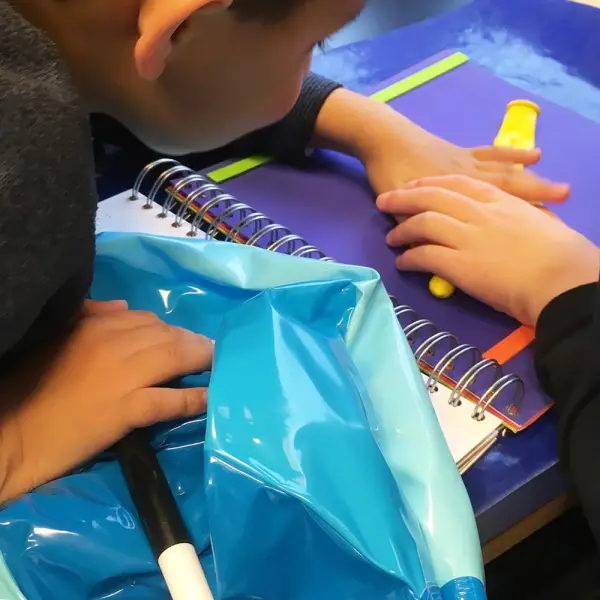 Two young boys reading the book.